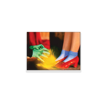 Dorothy wearing Ruby Slippers from The Wizard of Oz and the witches green handswith sparks in the background